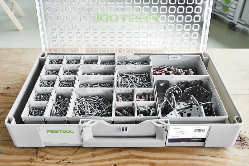 Festool Systainer storage box opened to reveal organized compartments filled with screws, fasteners, and hardware in various sizes