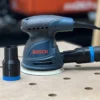 Use your standard shop vac or Festool dust extractor with your Bosch sander