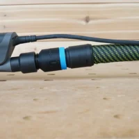 Hose adapter with blue band attached to 3M Xtract sander dust port, connected to green and black braided hose