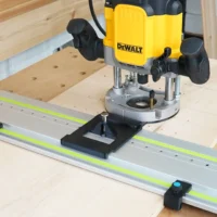 Black LR 32 plate with spring-loaded indexing knob on a Festool rail under a DeWalt plunge router, with rail stops