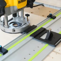 Dewalt 625 router mounted on LR 32 rail system with black adapter plate, guide stops, and spring-loaded knob on Festool-style track