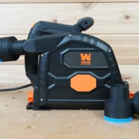 Black 2-1/2 inch ToolCurve hose adapter with blue ring joining a vac hose to a Wen track saw dust port, spares beside