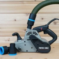 Black 36mm hose adapter with blue band installed on a Porter Cable belt sander dust port, second adapter beside it