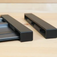 Two black protective caps for Ridgid track saw rails, one installed on an aluminum rail and one shown separately
