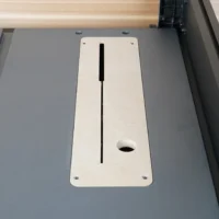 White MDF zero clearance insert mounted in SKIL 10" table saw, showing centered slot and mounting holes