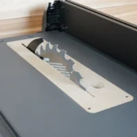 MDF zero clearance insert installed in a SKIL 10-inch table saw with blade and riving knife raised through the slot