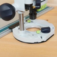Guide Rail Adapter for 1400 router mounted on Festool track, showing white base plate with central opening and attached router above