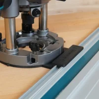 Guide rail adapter mounted on a Makita 40v router, secured to a Festool-style track saw rail
