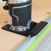 Metabo HPT cordless trim router mounted on black rail adapter connected to Festool guide rail