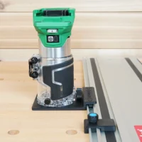 Metabo HPT trim router mounted on black rail adapter connected to Festool track saw guide rail, shown on workbench