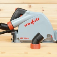 No Snag Dust Port adapter mounted on a Mafell MT 55cc track saw, with angled hose connector pointing upward and separate twist-lock adapter in foreground
