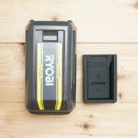 Ryobi 40v battery mount shown next to Ryobi 40v battery for size comparison on wooden surface