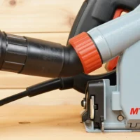 No-Snag Dust Port adapter with orange grip collar attached to Mafell track saw dust port, black hose connected below