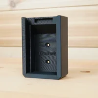 Black plastic battery holder mount for Ryobi 40v batteries, shown from front with two mounting holes and slot opening visible