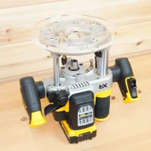 Clear 8-inch round acrylic router base plate mounted on an upside-down DeWalt cordless plunge router