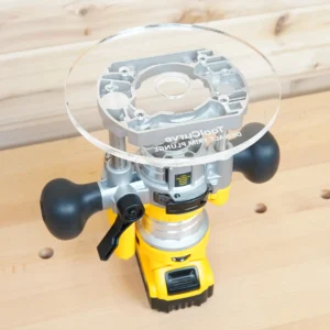 Clear 8-inch round acrylic router base plate marked Dewalt Trim Plunge, mounted on a yellow Dewalt DNP612 plunge router