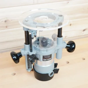 Clear 8-inch round acrylic router base plate mounted on an upside-down Porter Cable 690 plunge router base