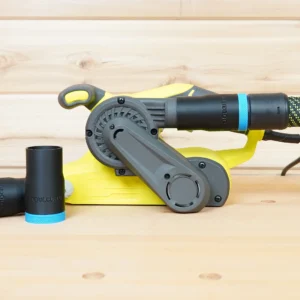 Black 27mm hose adapter with blue collar installed on a yellow Ryobi belt sander, second adapter lying beside it